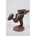 An unusual Indonesian wood figure carved as a stand, 9" high