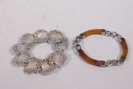 A white metal and horn bracelet, and a silver coloured metal bracelet