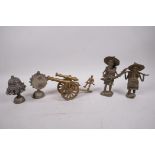 A collection of assorted metal items to include a brass table cannon, two Benin style figures and