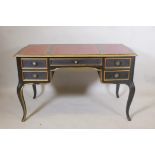 A French style ebonised and parcel gilt five drawer desk, with gilt tooled leather inset top, raised