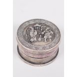 A Chinese circular white metal ink box, the cover decorated with figures, 1¾" diameter