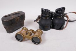 A cased pair of brass and mother of pearl opera glasses, and a pair of compact WWII field glasses,