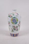 A Chinese polychrome porcelain vase decorated with fruiting peach branches, bats and auspicious