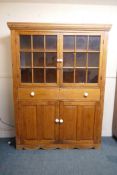 A C19th pine side cabinet, with two glazed doors over a long drawer and two cupboards, 60" x 14" x