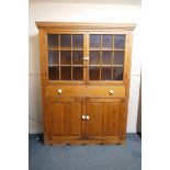 A C19th pine side cabinet, with two glazed doors over a long drawer and two cupboards, 60" x 14" x