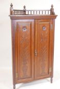 A Victorian Arts & Crafts walnut standing corner cupboard, with galleried top and two doors with