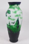 An overlaid green glass vase with decoration of sailing boats off the coast, in the style of