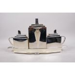 A Christopher Dresser style silver plated three section tea set, 15½" long