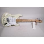An unused Fender Stratocaster guitar bearing signatures from the band Bon Jovi, 39" long