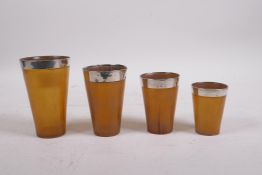 A set of four stacking horn beakers with silver mounts, London 1922, makers mark of Henry