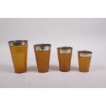 A set of four stacking horn beakers with silver mounts, London 1922, makers mark of Henry