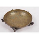 A small engraved brass bowl with Egyptian revival decoration raised on five phoenix supports, made