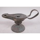 A Roman bronze oil lamp on pedestal base, 7" long