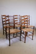 A set of five early C20th ladderback chairs with rush seats, A/F damaged stretchers and seat rails