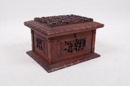 A Chinese carved camphorwood jewellery box, decorated with figures in a landscape, 7" x 5"