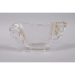 A Chinese moulded glass libation cup with pierced dragon decoration, 4½" long