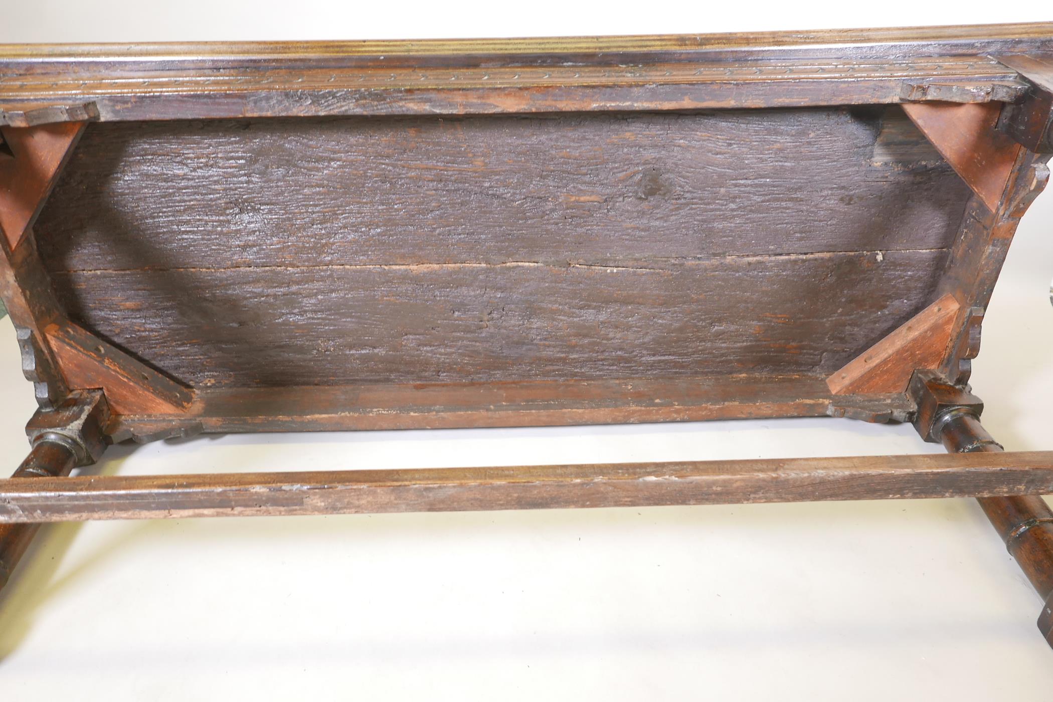 An antique oak refectory table, with plank top and carved frieze raised on gun barrel turned - Image 6 of 9