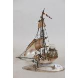 A C19th French mother of pearl and oyster shell desk stand in the form of a sailing boat, with brass
