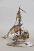 A C19th French mother of pearl and oyster shell desk stand in the form of a sailing boat, with brass