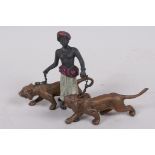 A cold painted bronze figure of an Arab gentleman with two tigers, 3" high