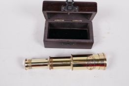 A small brass telescope in a hardwood box, 3¼"