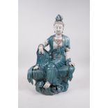 A Chinese teal and white glazed porcelain Quan Yin, impressed seal marks verso, 16½" high