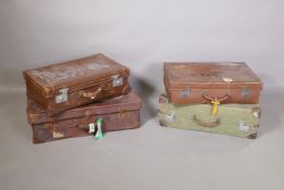 Four vintage suitcases (2 leather and 2 canvas) with original travel stickers, largest 29" x 17"