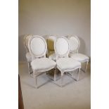 A set of fine French style carved and painted spoon back chairs, raised on fluted supports