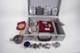 A flight case containing various silver plated items including hip flasks, cruets etc, and a