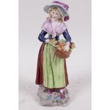 A Dresden porcelain figure of a girl selling oranges, 7" high