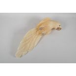 A carved yellow quartz figure of a parrot, 17½" long, A/F losses