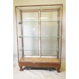 An early C20th shop display cabinet, the rear doors with etched decoration and company logo "S & S",