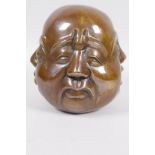 A Chinese bronze four faced Buddha head, 5" high