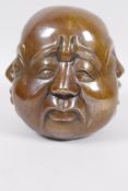 A Chinese bronze four faced Buddha head, 5" high