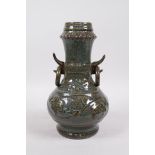 A crackle glazed Song style pottery vase with ring handles and raised scrolling floral decoration,
