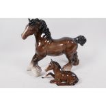 A Beswick figurine of a shire horse, 8" high, and another of a foal lying down, number 915