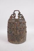 A Chinese bronze bell with raised archaistic decoration, 11" high