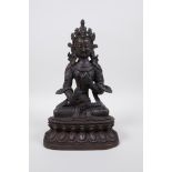 A Tibetan bronze figure of Buddha seated on a lotus throne, 8½" high