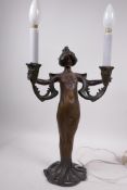 An Art Nouveau bronzed metal two light table lamp by Lucien Alliot, cast in the form of a