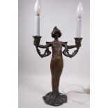 An Art Nouveau bronzed metal two light table lamp by Lucien Alliot, cast in the form of a
