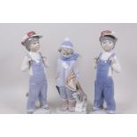 Three Lladro figures of young boys, one with puppy, 8½" high