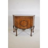 A 1920s walnut serpentine front side cabinet, with burr walnut inlaid top and carved edge over a