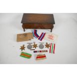 A collection of five medals from the Second World War; the Defence Medal, Africa Star, Italy Star