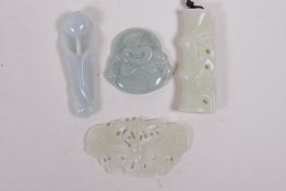 Four Chinese celadon jade pendants, carved in the form of bamboo, butterfly, Buddha and a flower,