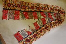 A Gujarati hand embroidered toran hanging, mid C20th, 172" long