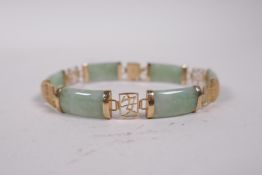 A 9ct yellow gold and green jade bracelet, the links decorated with Chinese characters, 7" long