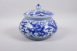 A Chinese Ming style blue and white porcelain jar and cover of squat form with dragon and phoenix