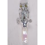 A replica Victorian style sterling silver and mother of pearl baby's rattle in the form of an owl,