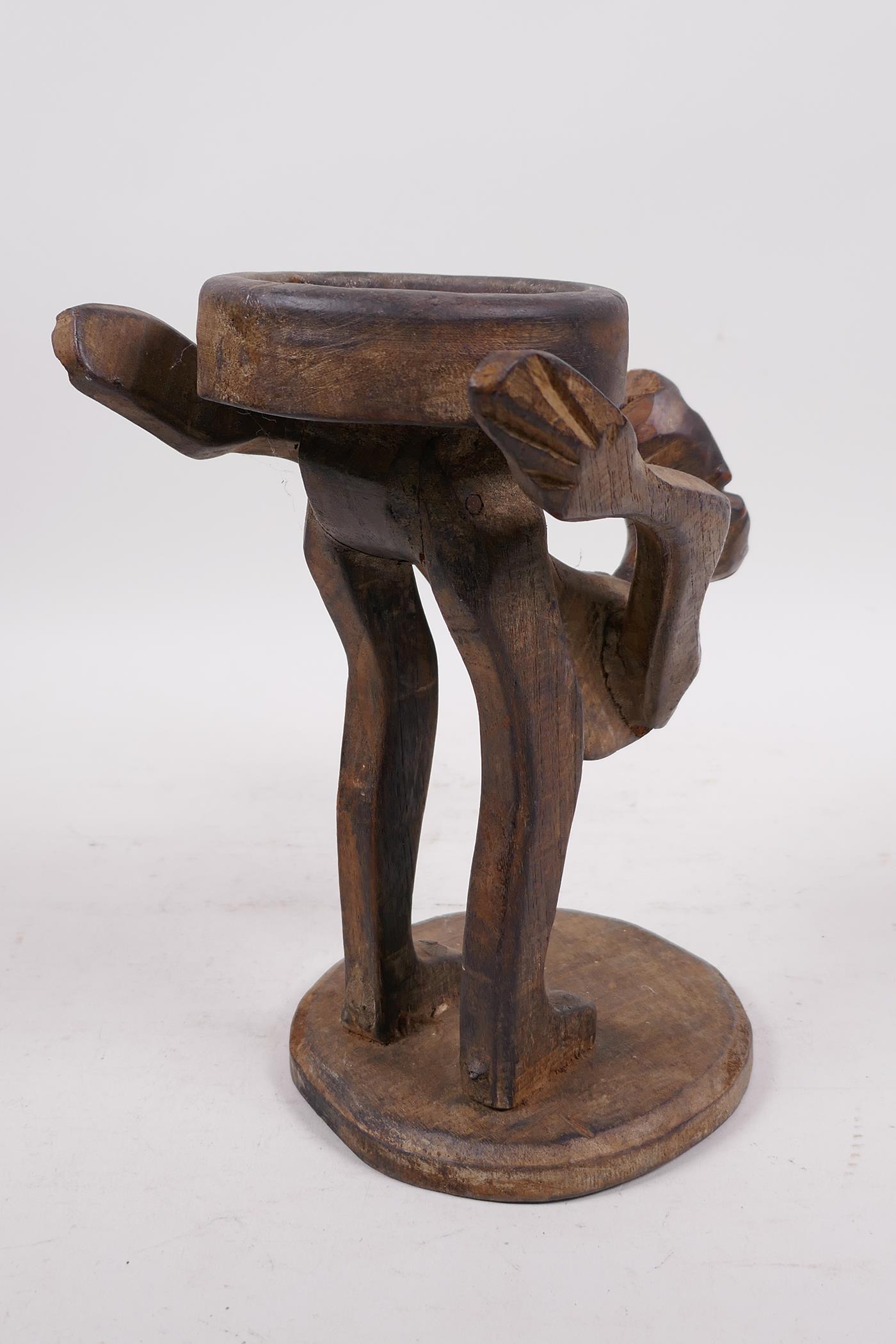 An unusual Indonesian wood figure carved as a stand, 9" high - Image 4 of 4