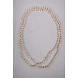 A long string of Mikimoto pearls, recently restrung, in an original Mikimoto silk case, 38" long